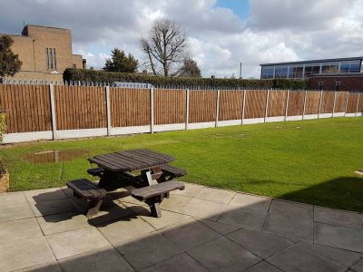 long commercial fencing installed six foot feathered edge fence with concrete gravel boards