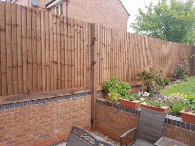 feathered edge fence above a brick wall installation