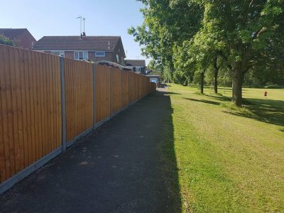 six foot tall fence with feathered edge pannels and concrete gravel boards