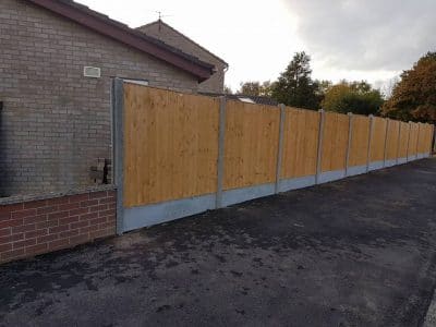 garden fence installed against drive way in corby